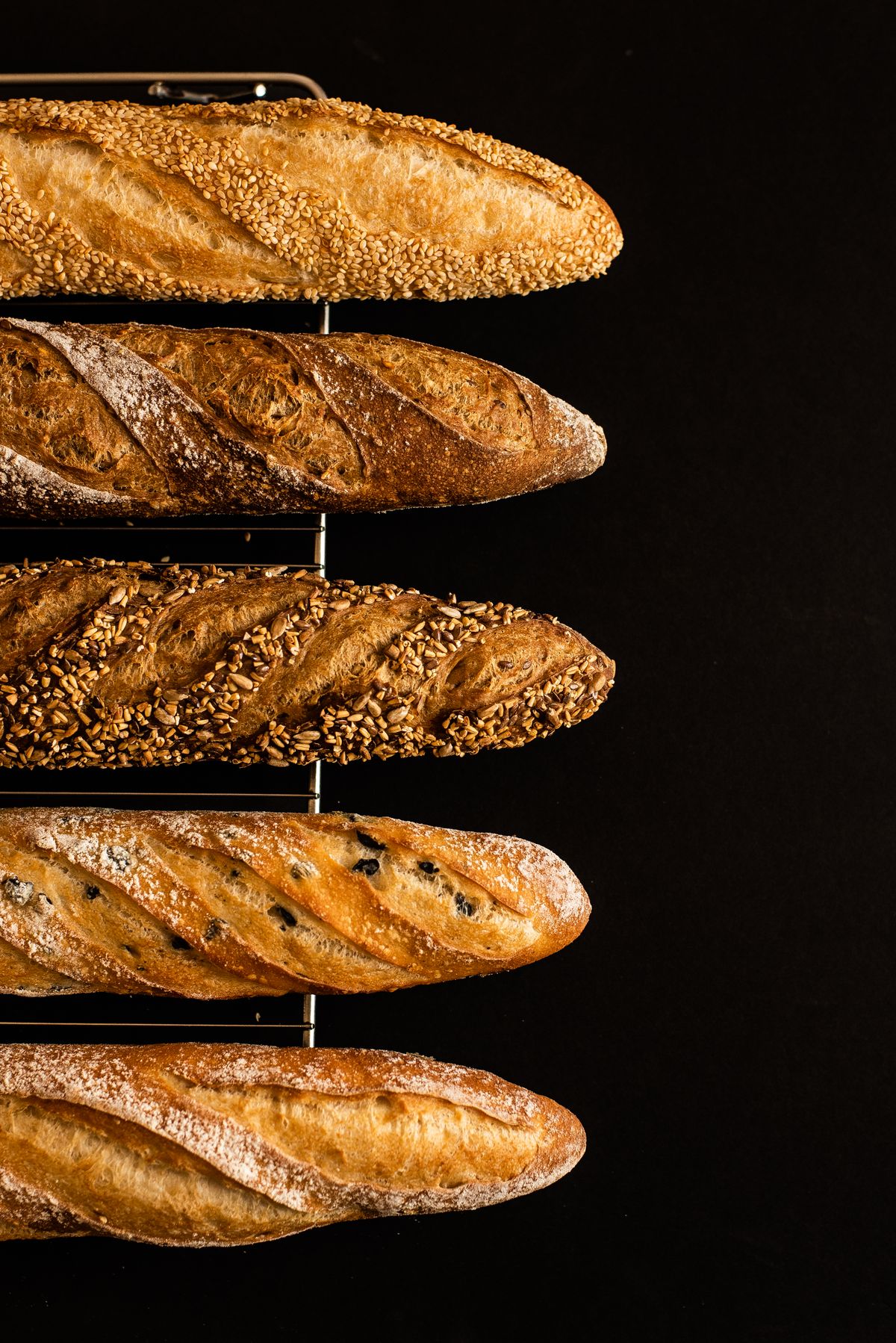 Artisan baguettes on a cooling rack