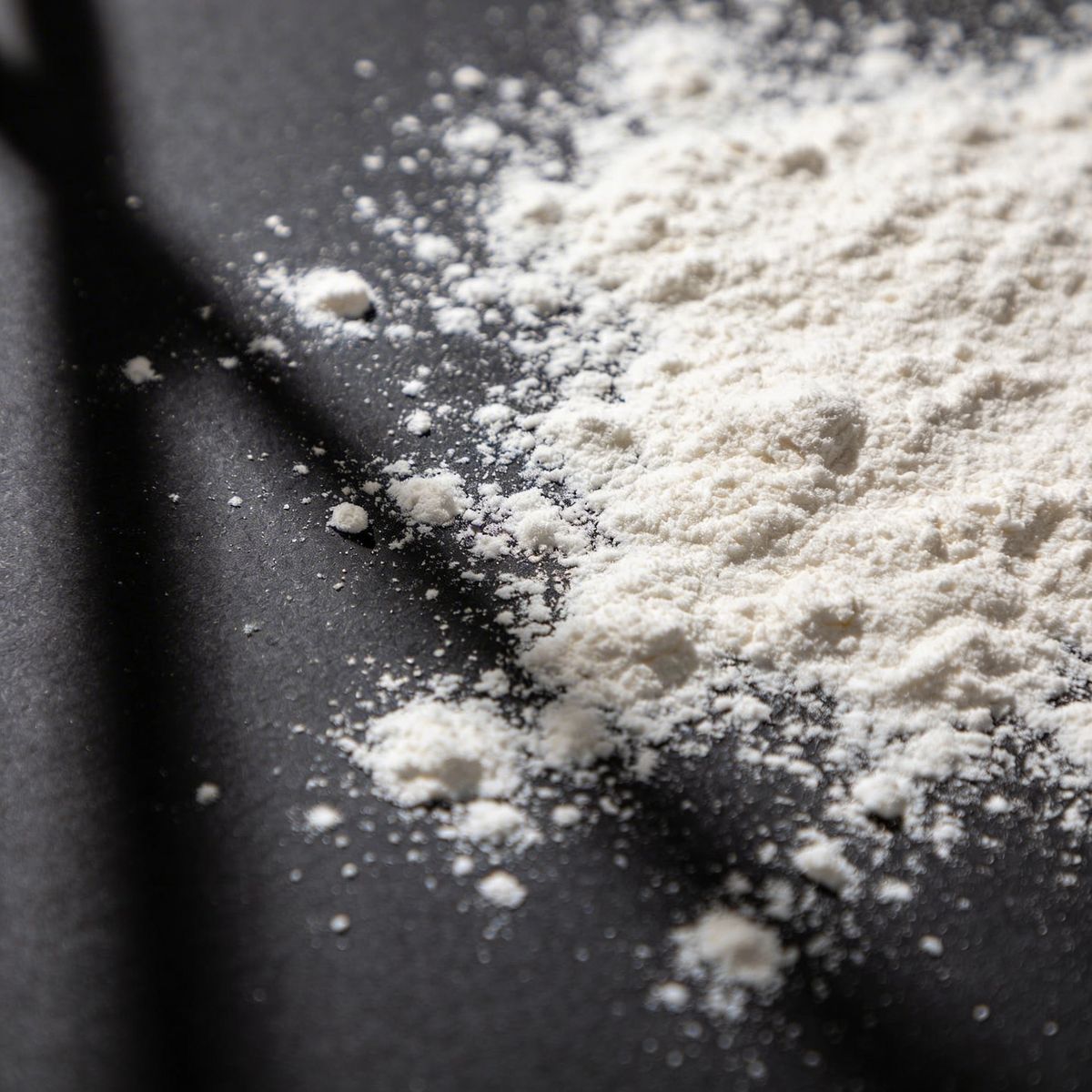 Flour scattered on a dark surface